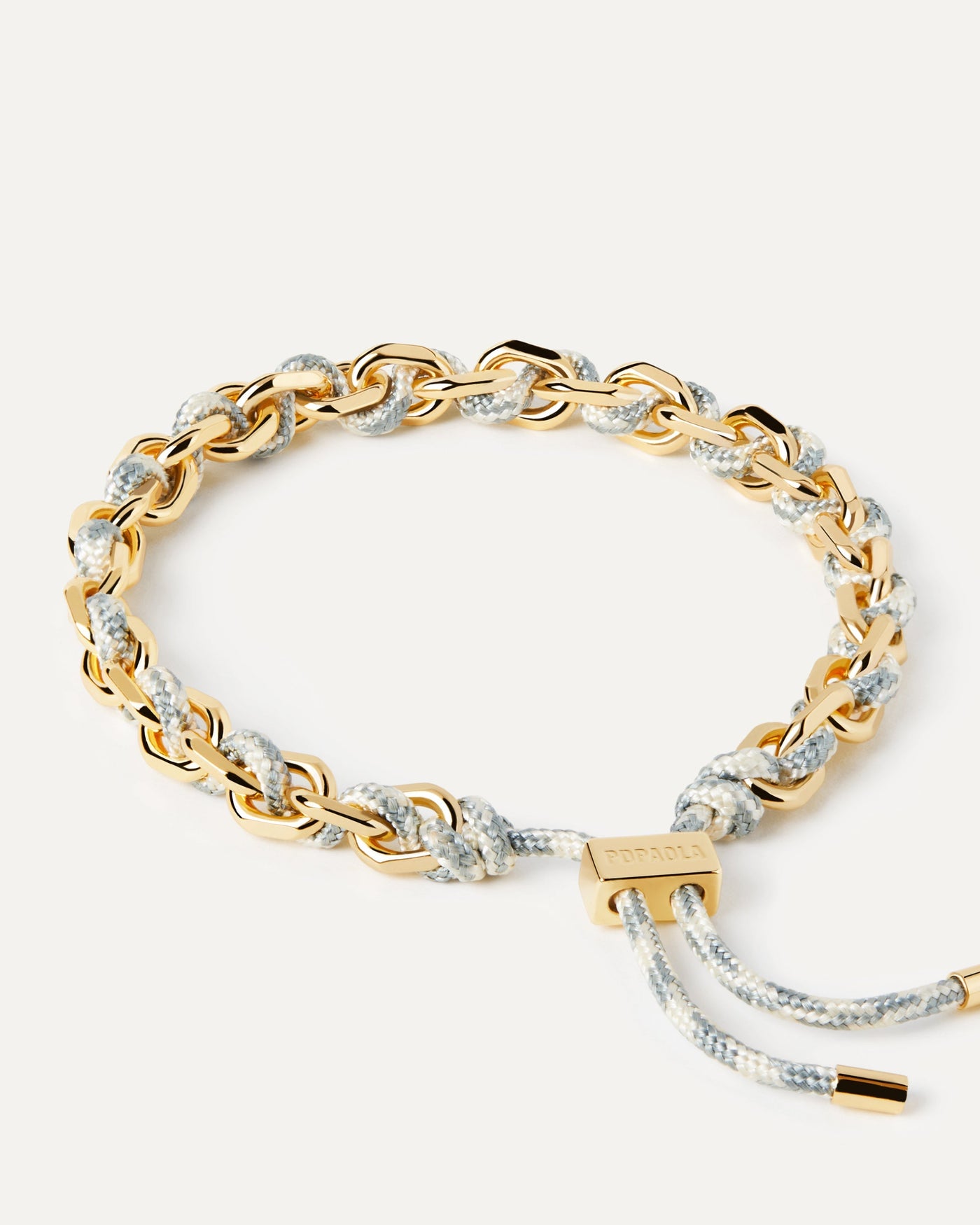 2023 Selection | Sky Rope and Chain Bracelet. Golden chain bracelet with a blue and white rope adjustable sliding clasp. Get the latest arrival from PDPAOLA. Place your order safely and get this Best Seller. Free Shipping.