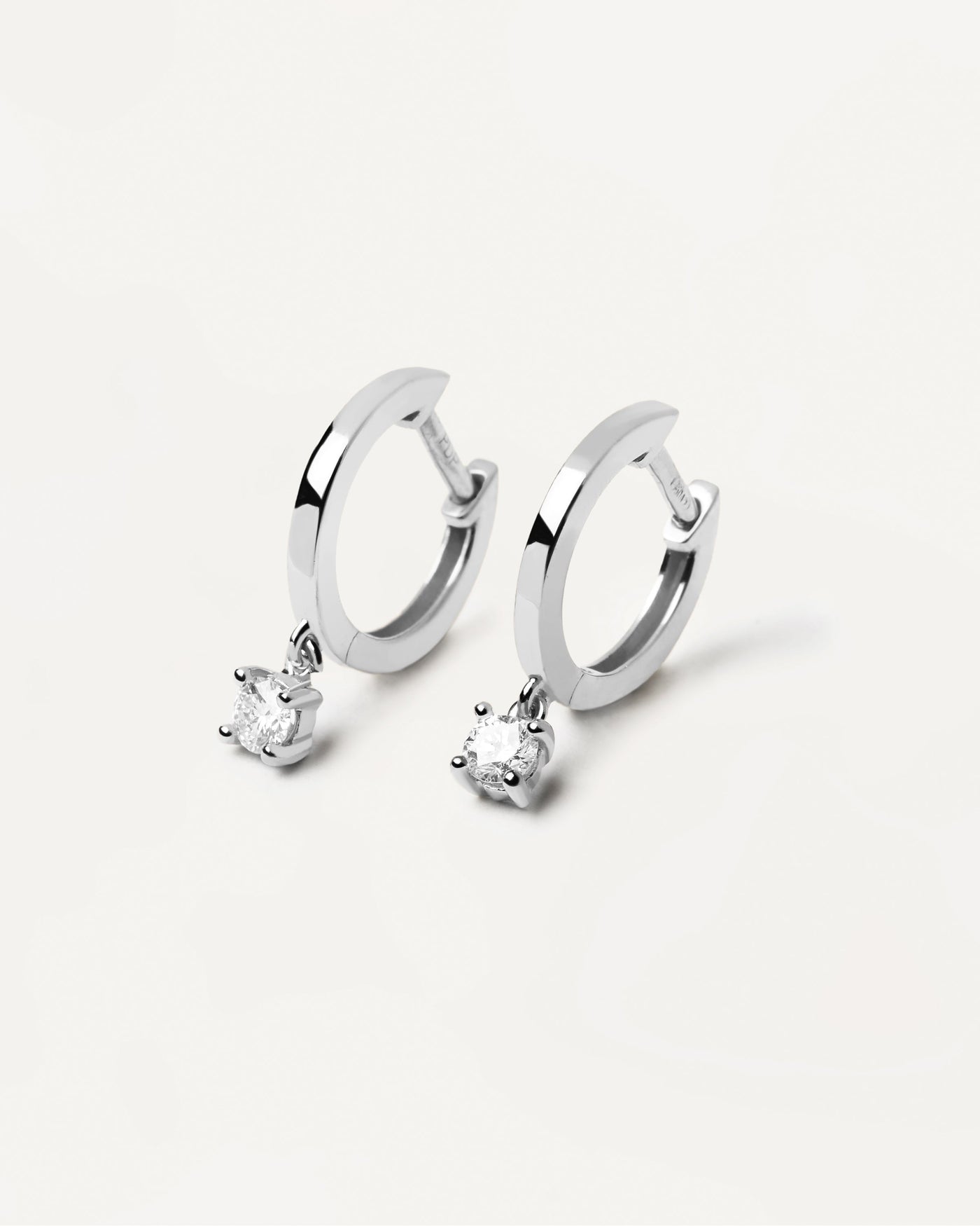 2024 Selection | Diamonds and White Gold Drop Hoops. Hoop earrings in solid white gold with hanging lab-grown diamond of 0.10 carats each. Get the latest arrival from PDPAOLA. Place your order safely and get this Best Seller. Free Shipping.