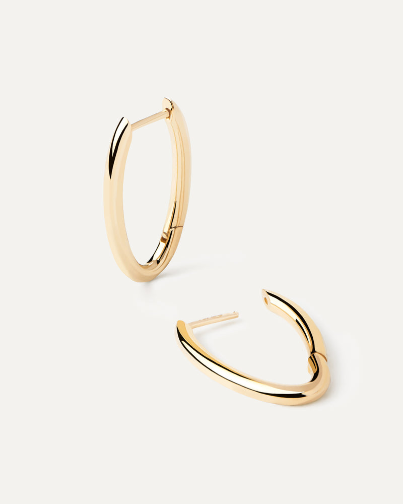 Distinctive oval shape hoop earrings in solid yellow gold