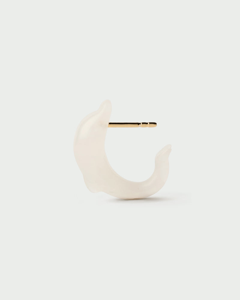 Minimalist dolphin ear piercing with a hand-sculpted white gemstone
