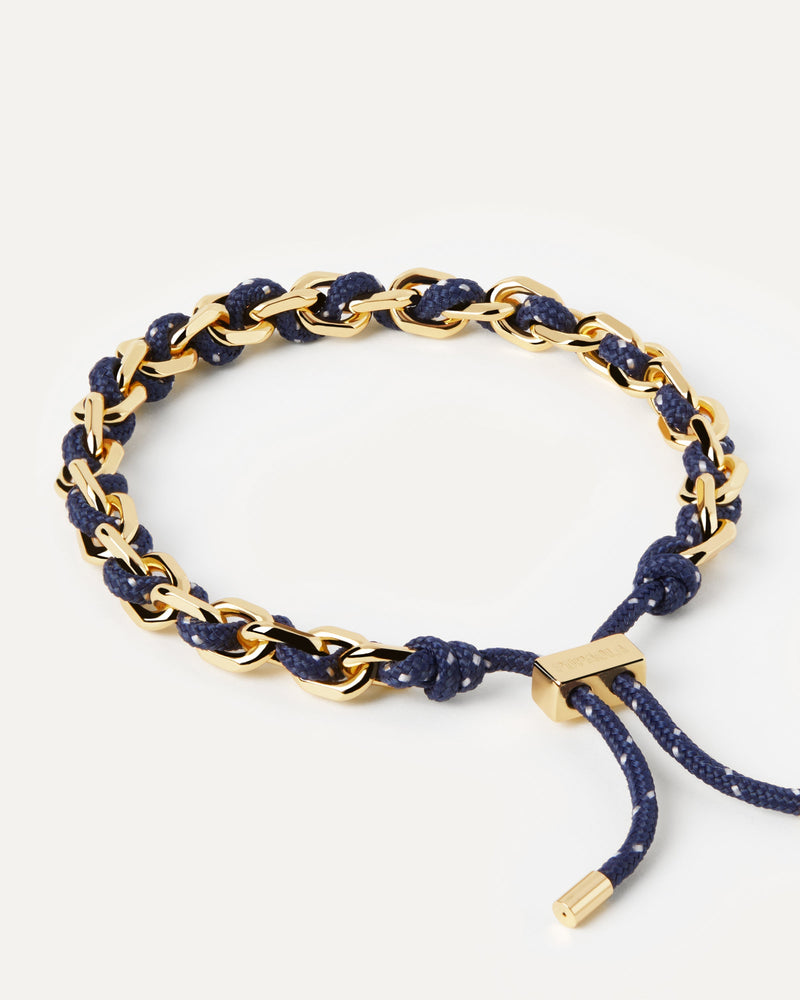 Golden tone chain bracelet with intertwined navy blue rope and adjustable sliding clasp