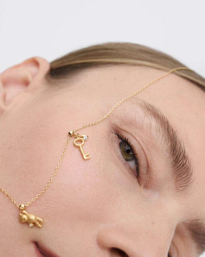 Charm Chiave - 
  
    Argento sterling / Placcatura in Oro 18K
  
