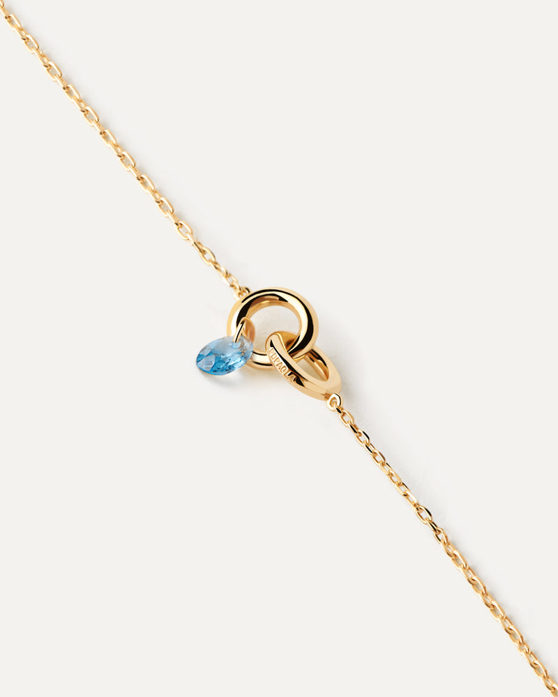 Bracciale con due anelli collegati tra loro e ciondolo con zirconi blu a goccia