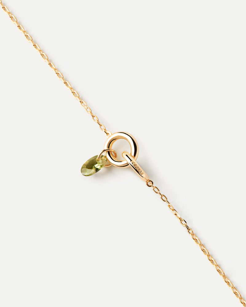Bracciale con due anelli collegati tra loro e ciondolo con zirconi verde a goccia