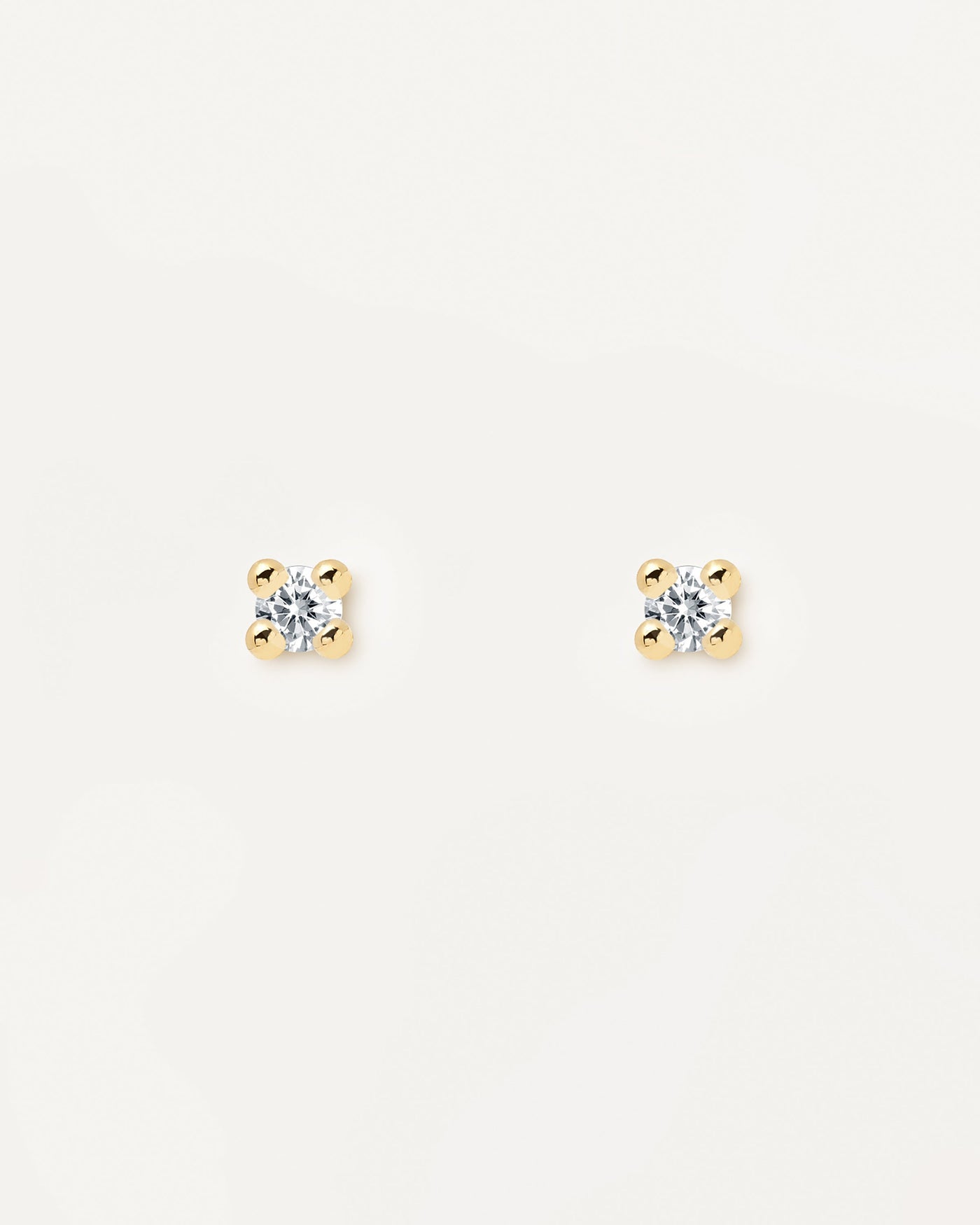 2023 Selection | Essentia Earrings. Pair of 18k gold plated silver stud earrings set with a white zirconia stone. Get the latest arrival from PDPAOLA. Place your order safely and get this Best Seller. Free Shipping.