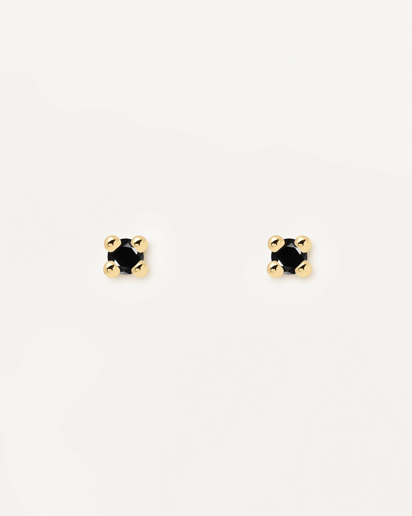 2023 Selection | Black Essentia Earrings. 18k gold plated silver stud earrings with a cut black zirconia . Get the latest arrival from PDPAOLA. Place your order safely and get this Best Seller. Free Shipping.