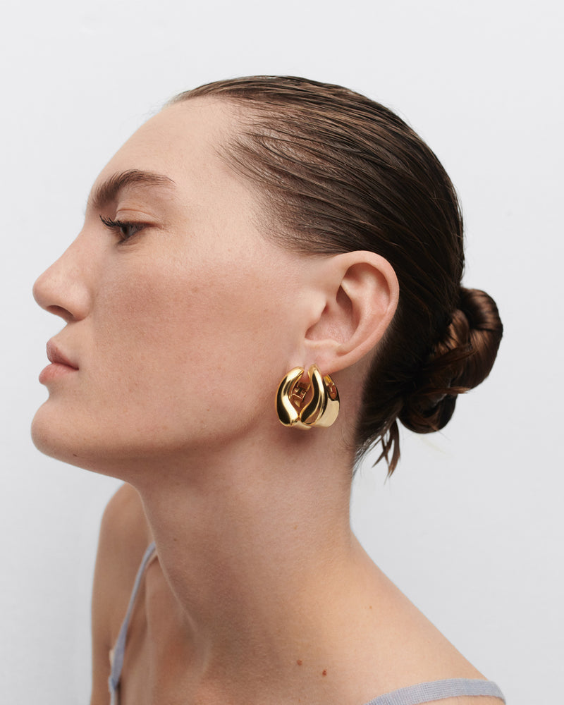 Gold-plated oversized geometric hoop earrings with a wavy bean shape