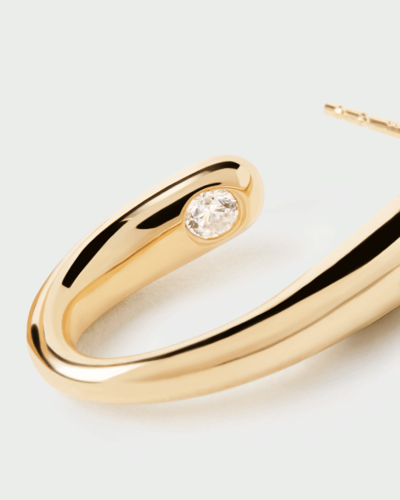 Gold-plated modern semi hoops accented with a round white zirconia