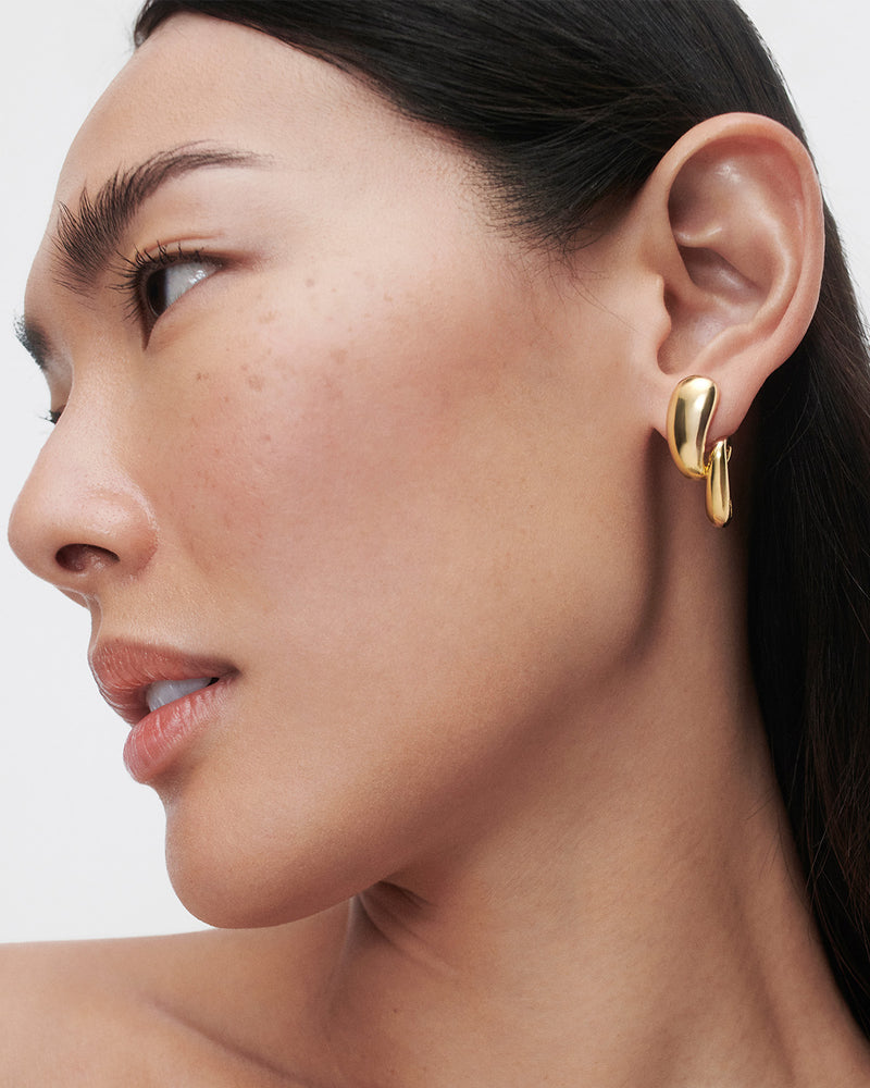 Gold-plated sculptural earrings with twisted drop motif