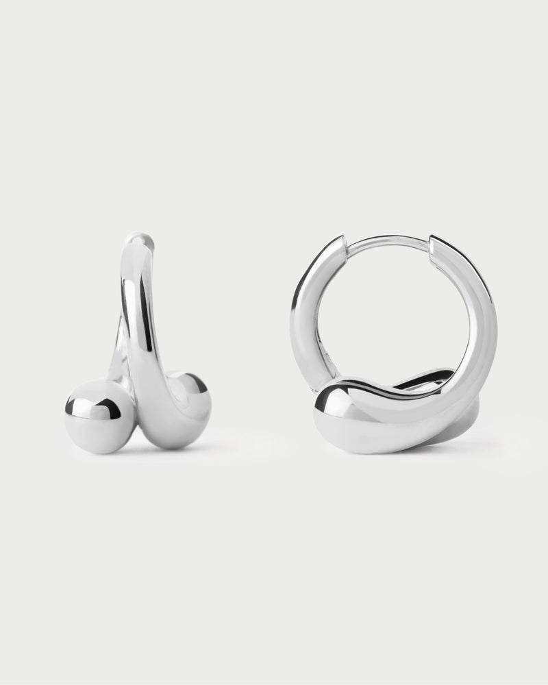 Modern silver huggie earrings with asymmetric design featuring two overlapping drop motifs