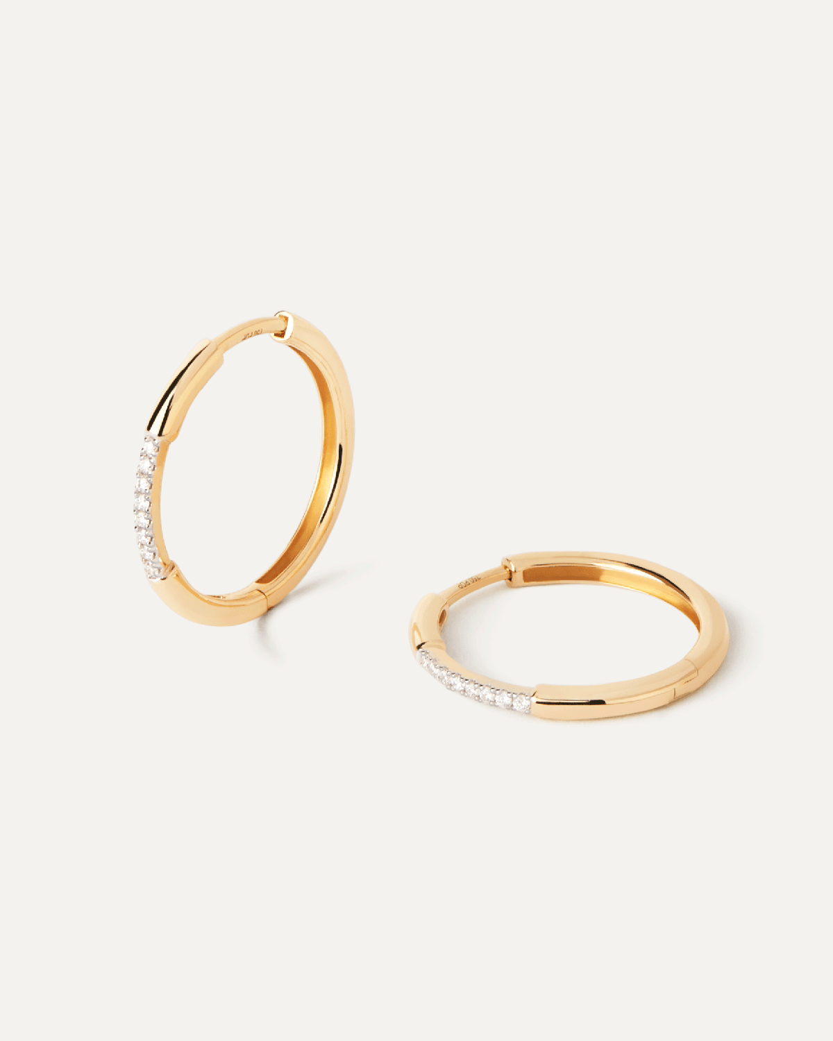 Diamonds and gold Nora hoops. Distinctive hoop earrings in solid yellow gold set with contrasting lab-grown diamonds . Get the latest arrival from PDPAOLA. Place your order safely and get this Best Seller.