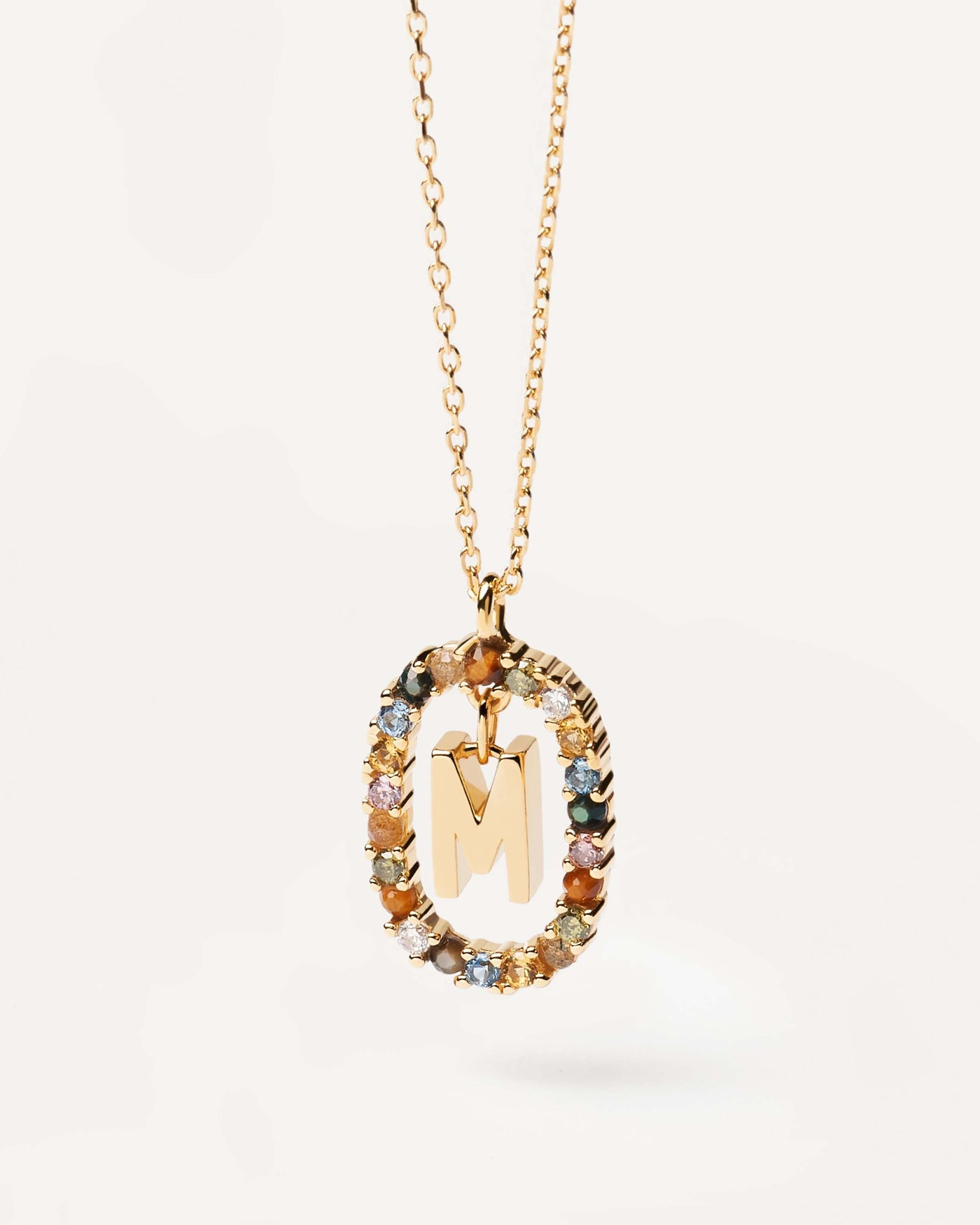 2023 Selection | Letter M necklace. Initial M necklace in gold-plated silver, circled by colorful gemstones. Get the latest arrival from PDPAOLA. Place your order safely and get this Best Seller. Free Shipping.