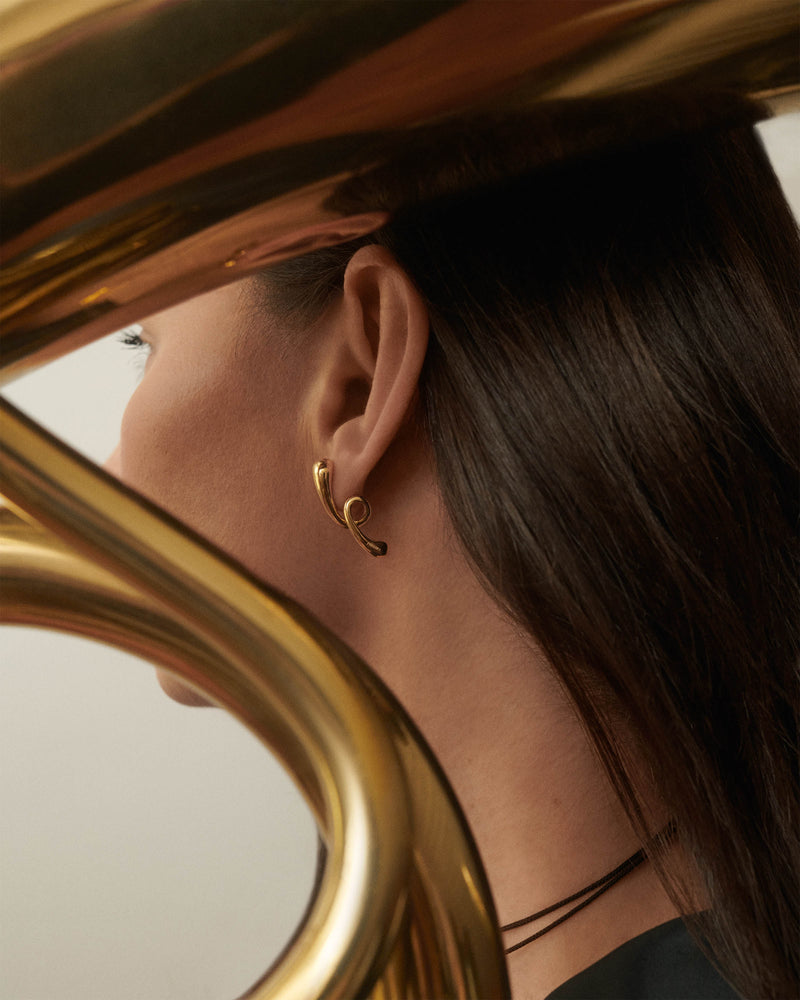 Gold-plated sculptural earrings with twisted drop motif
