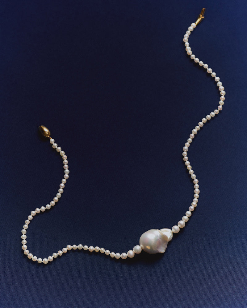 Modern pearl beaded necklace accented with a large irregular freshwater cultured pearl