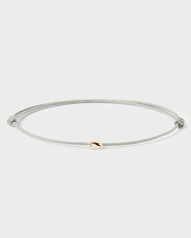 Adjustable diamond cord bracelet featuring a drop flush set with a lab-grown diamond